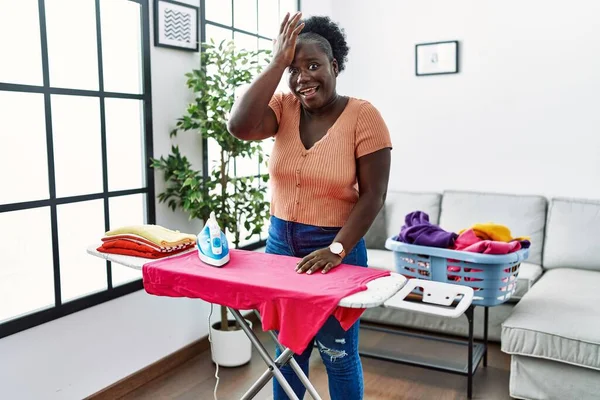 Young African Woman Ironing Clothes Home Surprised Hand Head Mistake — Stock Photo, Image