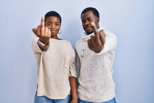 Young African American Couple Standing Blue Background Together Showing Middle — Foto de Stock