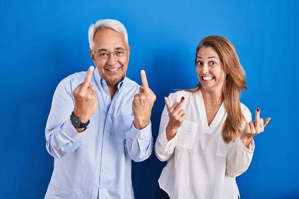 Middle Age Hispanic Couple Standing Blue Background Showing Middle Finger — Photo