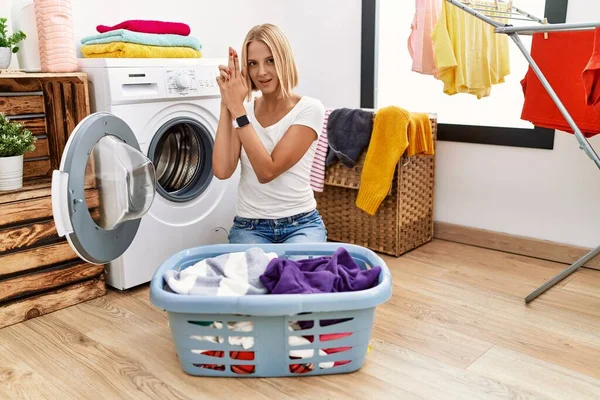 Young Caucasian Woman Doing Laundry Clothes Basket Holding Symbolic Gun —  Fotos de Stock