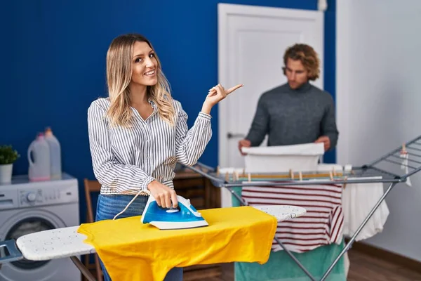 Couple Ironing Clothes Laundry Room Smiling Happy Pointing Hand Finger — Stok fotoğraf