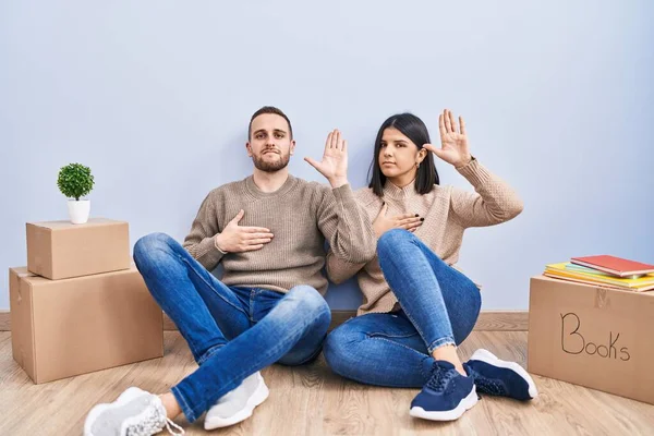 Young Couple Moving New Home Swearing Hand Chest Open Palm — Stock Photo, Image