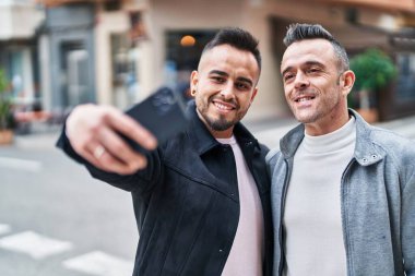 Two men couple smiling confident make selfie by smartphone at street