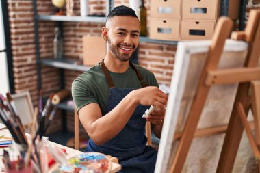 African american man artist smiling confident drawing at art studio