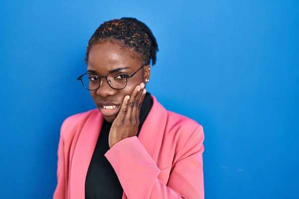 Beautiful Black Woman Standing Blue Background Touching Mouth Hand Painful — Stockfoto