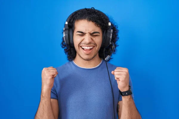 Hispanic Man Curly Hair Listening Music Using Headphones Excited Success — Stock Photo, Image