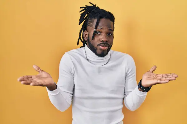 African Man Dreadlocks Wearing Turtleneck Sweater Yellow Background Clueless Confused — Stock Photo, Image