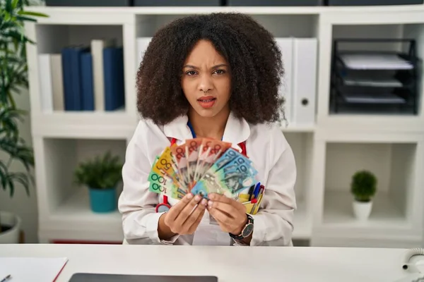 Young African American Doctor Woman Holding Australian Dollars Banknotes Clueless — Stockfoto