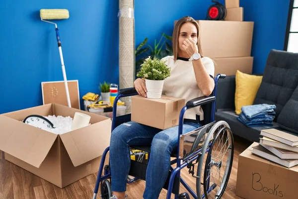 Young Woman Sitting Wheelchair Moving New Home Smelling Something Stinky — ストック写真