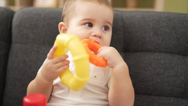 Adorable Toddler Playing Hoops Sitting Sofa Bitting Hoop Home — Stockfoto