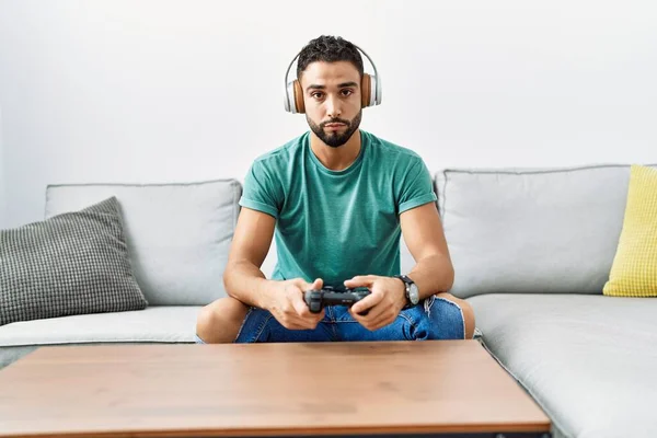 Snygg Hispanic Man Bär Hörlurar Spelar Spel Innehav Controller Tänkande — Stockfoto