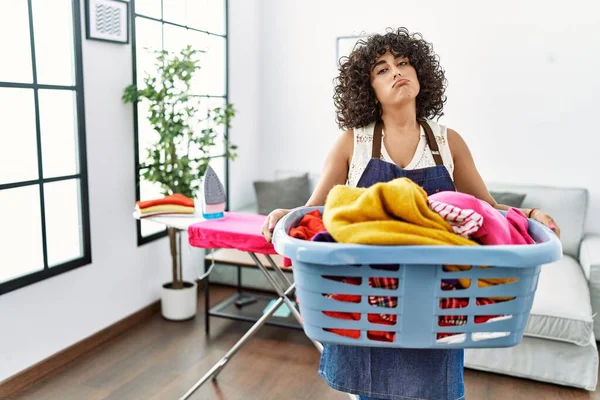 Young Middle East Woman Holding Laundry Basket Home — Stockfoto