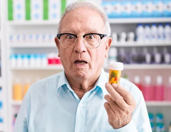 Senior Man Grey Hair Holding Pills Pharmacy Scared Amazed Open — Stock Photo, Image