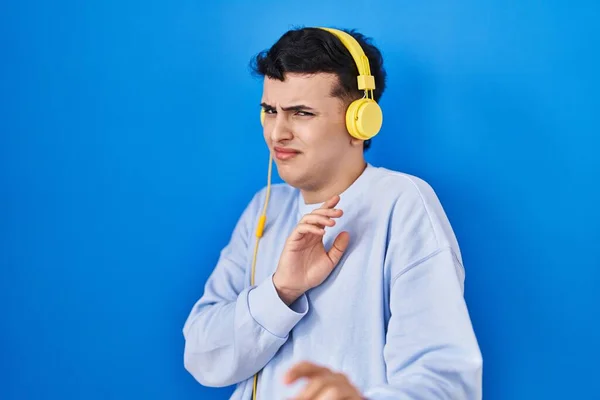 Non Binary Person Listening Music Using Headphones Disgusted Expression Displeased — Stock Photo, Image