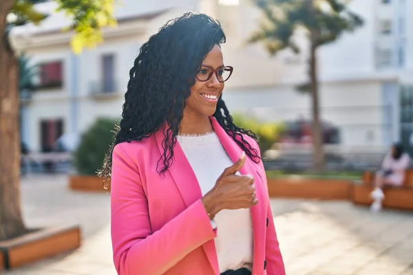 African american woman executive smiling confident doing ok gesture with thumb up at park