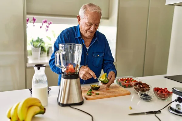 Senior Man Smiling Confident Cutting Avocado Kitchen — Stock Photo, Image