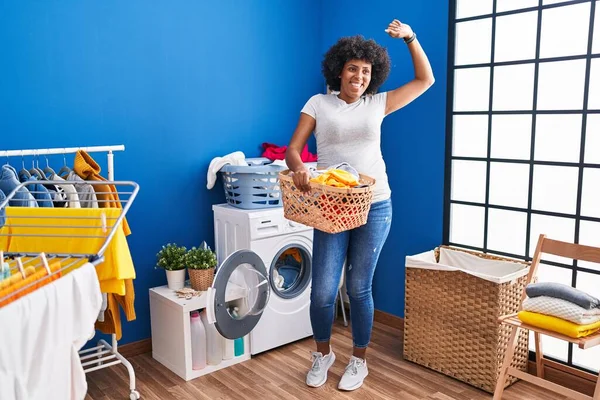 African American Woman Smiling Confident Holding Basket Clothes Laundry Room — ストック写真