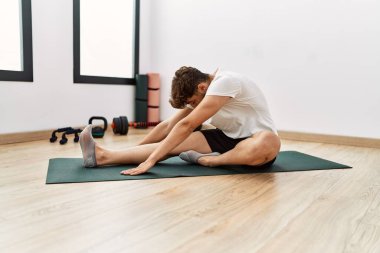 Young arab man stretching at sport center