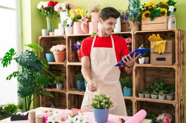 Çiçekçide kendinden emin gülümseyen İspanyol bir çiçekçi.