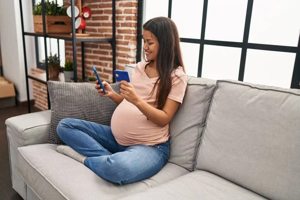 Jonge Latijnse Vrouw Zwanger Met Smartphone Creditcard Thuis — Stockfoto