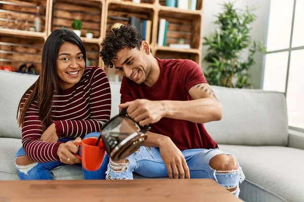 Young Latin Couple Smiling Happy Drinking Coffee Sitting Sofa Home — Stock Photo, Image
