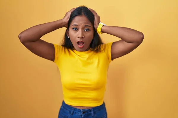 Young Indian Woman Standing Yellow Background Crazy Scared Hands Head — Stock Photo, Image