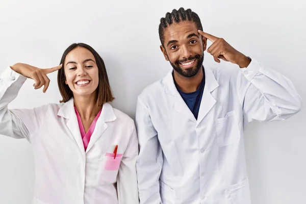 Young Hispanic Doctors Standing White Background Smiling Pointing Head One —  Fotos de Stock