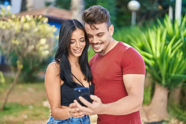 Man Woman Couple Smiling Confident Using Smartphone Park — Stok fotoğraf