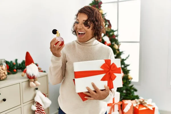Middle Age Hispanic Woman Holding Gift Standing Christmas Tree Home — Stock Photo, Image