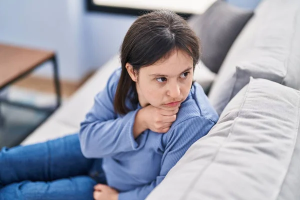 Young Woman Syndrome Sitting Sofa Serious Expression Home — Stock Photo, Image