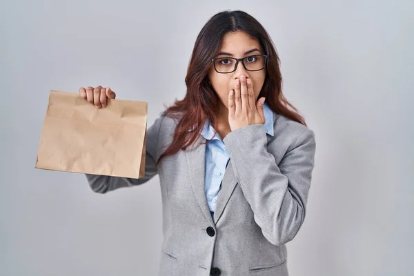 Hispanic Young Woman Holding Take Away Bag Covering Mouth Hand — Stock Photo, Image