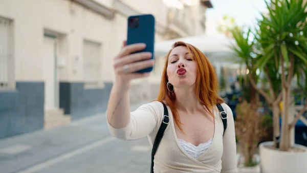 Молодая Рыжая Женщина Делает Селфи Смартфоне Целуется Улице — стоковое фото