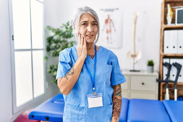 Medelålders Gråhårig Kvinna Bär Sjukgymnast Uniform Läkarmottagningen Röra Munnen Med — Stockfoto