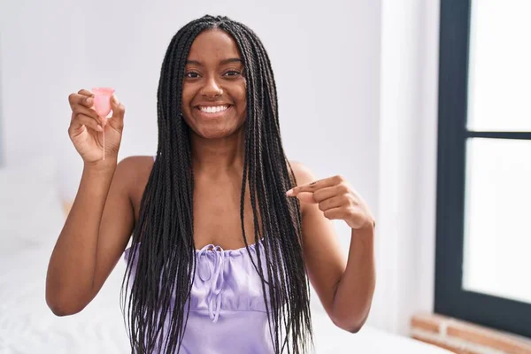 Stock image Young african american with braids holding menstrual cup pointing finger to one self smiling happy and proud 