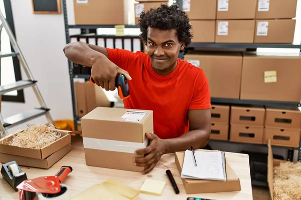 stock image Young south east man using barcode reader device working at storehouse