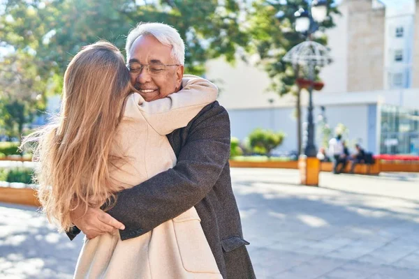 stock image Middle age man and woman couple hugging each other standing at park