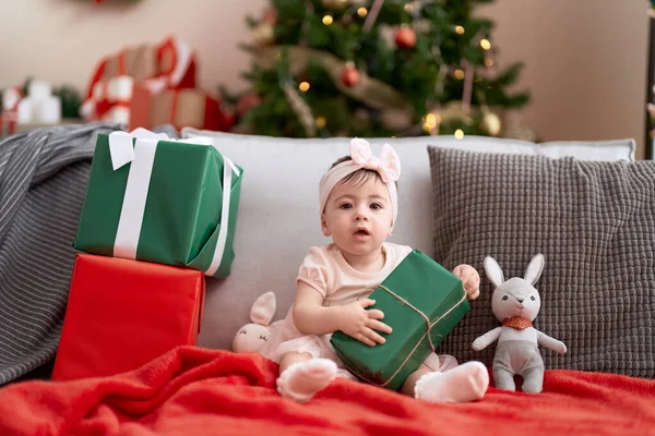 Adorable Toddler Opening Christmas Gift Sitting Sofa Home — Stock Photo, Image