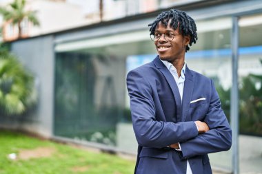 African american man executive smiling confident standing with arms crossed gesture at park