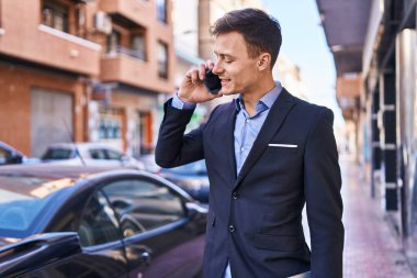 Young man business worker smiling confident talking on smartphone at street