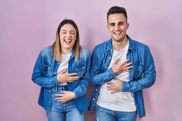 Young Hispanic Couple Standing Pink Background Smiling Laughing Hard Out — Stockfoto