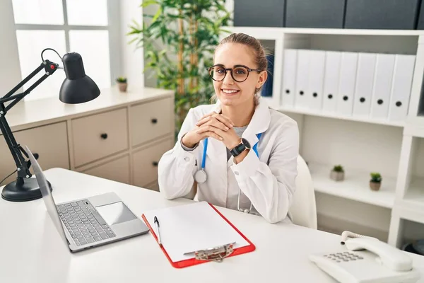 Young Blonde Woman Wearing Doctor Uniform Working Clinic —  Fotos de Stock