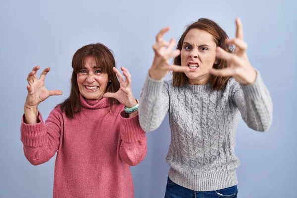Mother Daughter Standing Blue Background Shouting Frustrated Rage Hands Trying — Stock Photo, Image