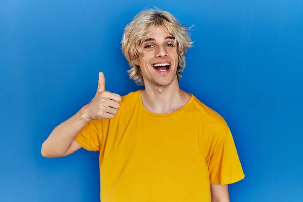 Young Modern Man Standing Blue Background Doing Happy Thumbs Gesture — Stockfoto