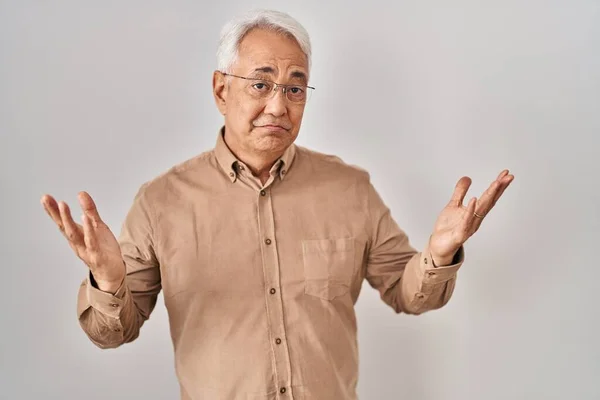 Hispanic Senior Man Wearing Glasses Clueless Confused Expression Arms Hands — Stockfoto