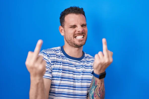 Young Hispanic Man Standing Blue Background Showing Middle Finger Doing — 스톡 사진