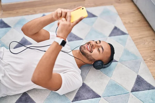 African American Man Listening Music Lying Floor Home — Stok fotoğraf