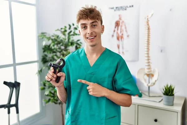 Young Caucasian Physio Man Holding Hand Grip Train Muscle Clinic — Stok fotoğraf