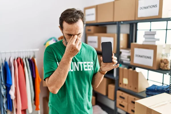 Middle Age Man Beard Wearing Volunteer Shirt Holding Smartphone Tired — Stock Photo, Image
