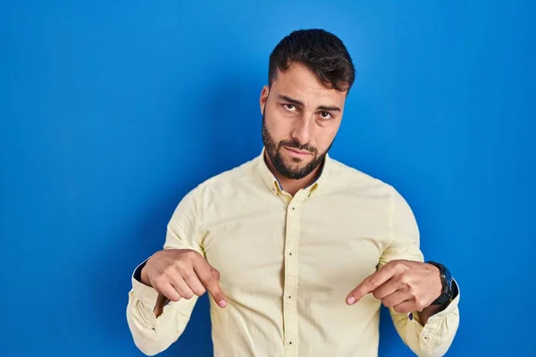 Handsome Hispanic Man Standing Blue Background Pointing Looking Sad Upset — Stock Photo, Image