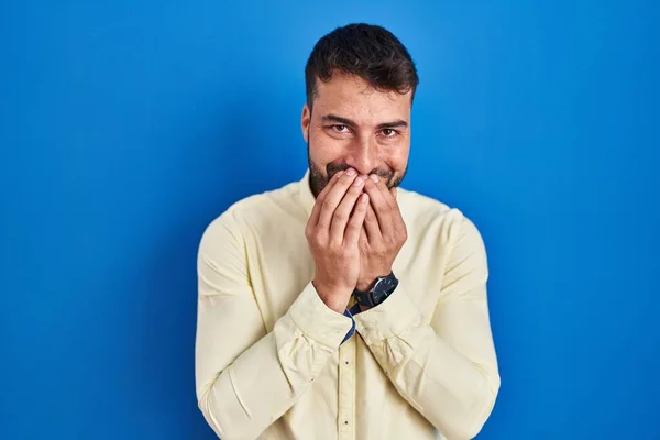 Handsome Hispanic Man Standing Blue Background Laughing Embarrassed Giggle Covering — Stockfoto